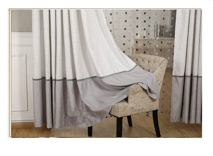 Single blackout curtain panel showing hook heading style with blackout lining visible at edge