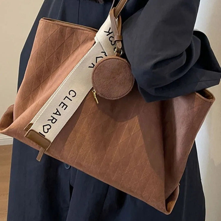 Large casual tote bag with shoulder strap in horizontal square shape with zippered internal compartment