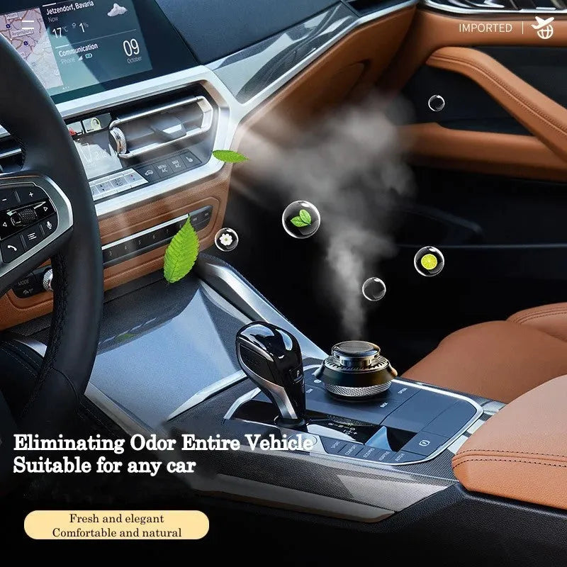 Black solar-powered kinetic double ring car air freshener diffuser on a car dashboard.