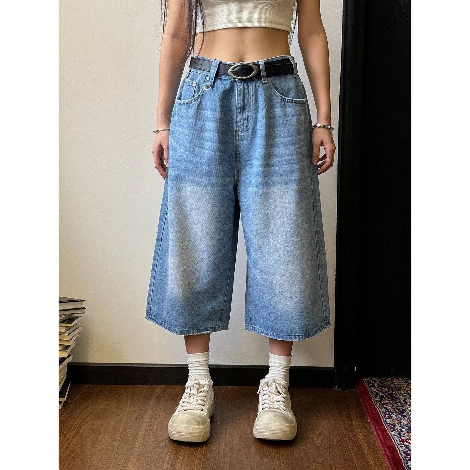 Men's loose straight-leg denim shorts in blue, shown with a fifth pants length for summer.