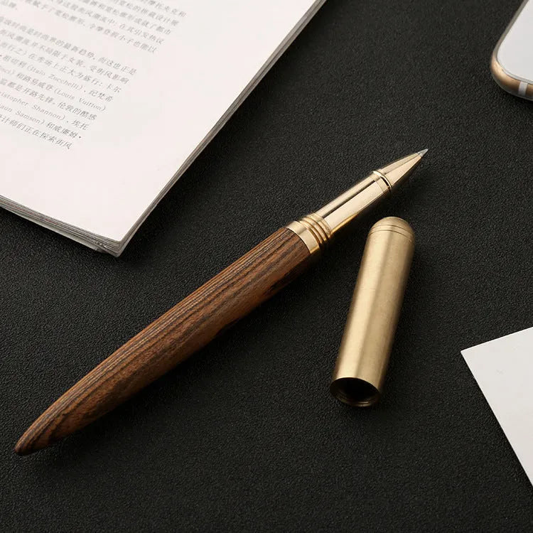 Brass and sandalwood solid wood signature pen with wooden barrel and brass fittings on a desk