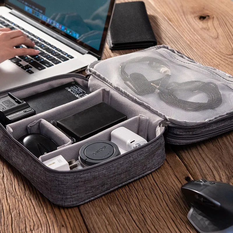 Grey waterproof electronics organiser with double-layer interior, adjustable dividers, and carrying handle