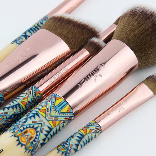 12 makeup brushes with man-made fibre bristles and wooden handles, arranged on a flat surface