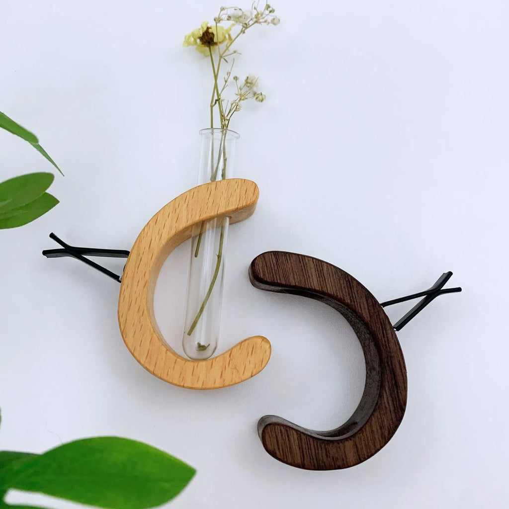 Wooden C-shaped car flower container in Beech finish on a car air vent