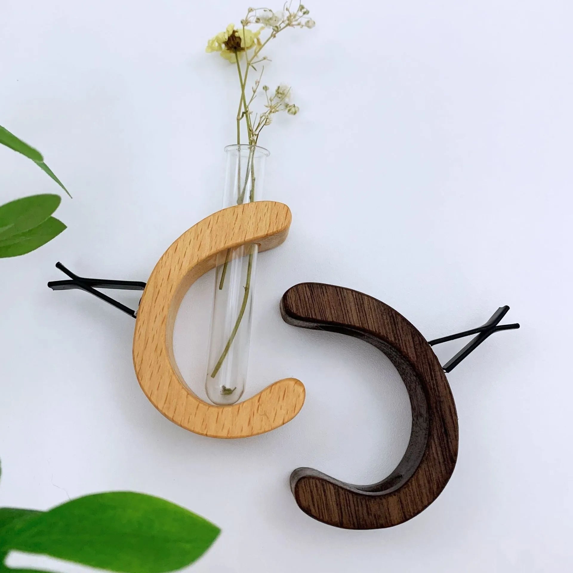 Wooden C-shaped car flower container in Beech finish on a car air vent