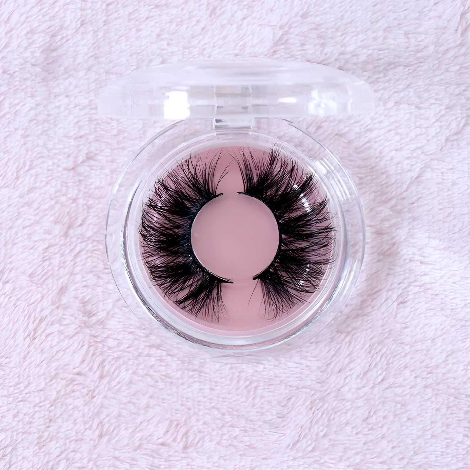 25MM3D handmade mink eyelashes in a clear plastic tray showing 25mm length 3D curl design