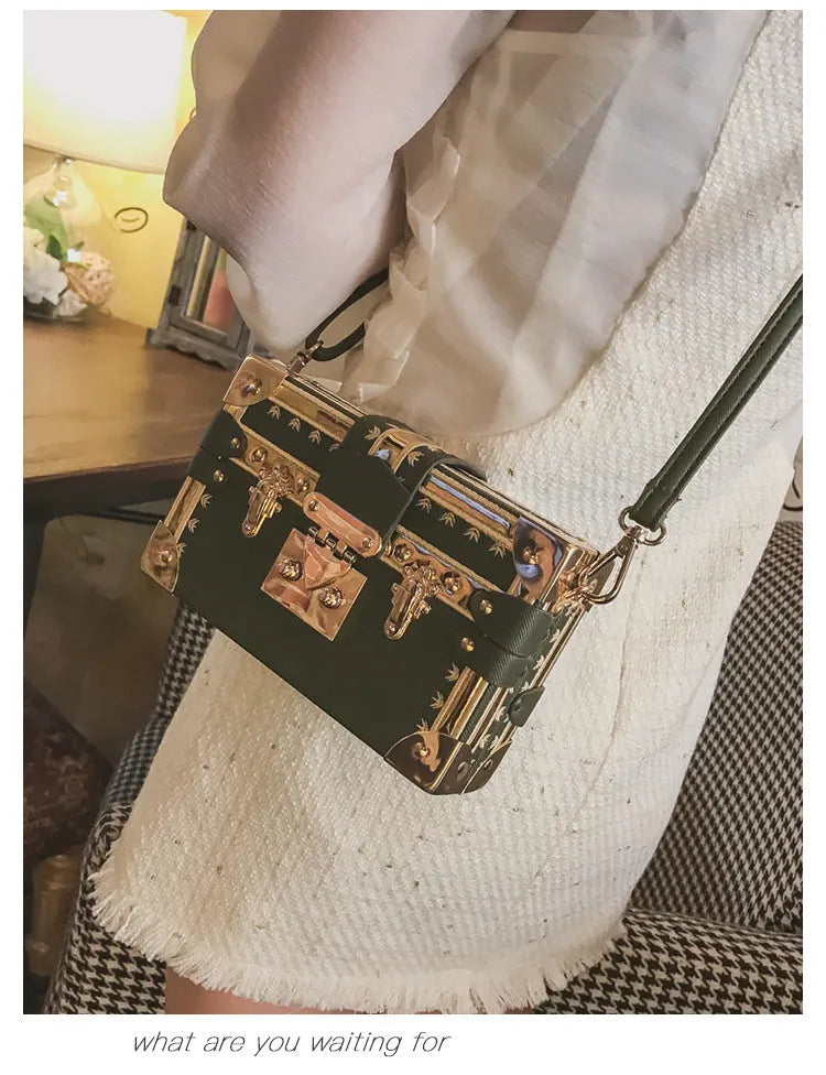 Women's hard PU shoulder bag with flap closure and crossbody strap in black colour with rivet decoration