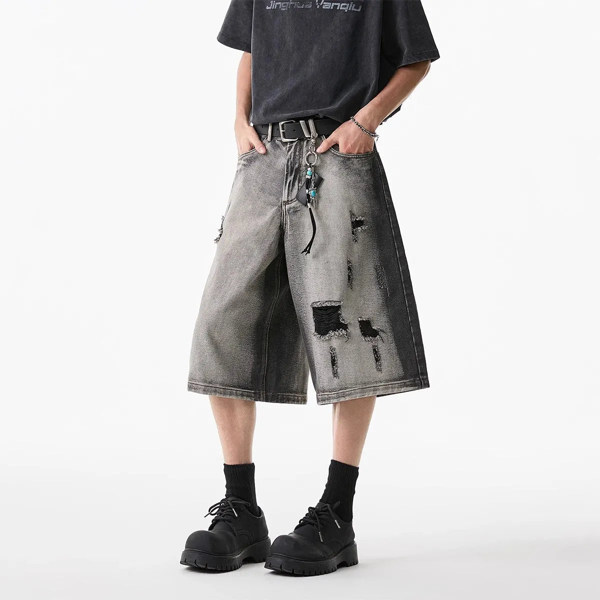 Grey cotton denim shorts with distressed hole finish and loose cropped fit