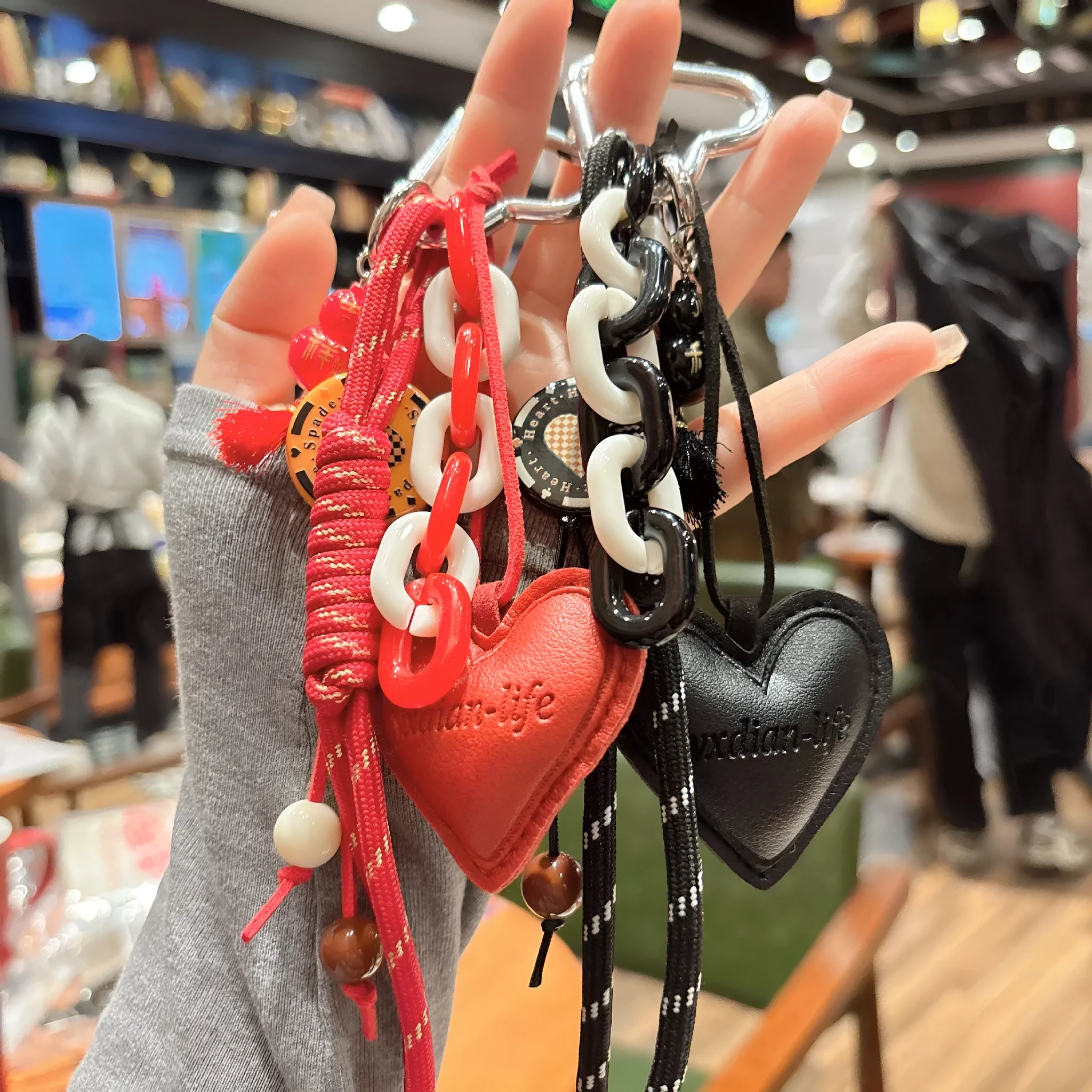 Leather heart-shaped and small gourd pendant keychain with woven rope loop, available in brown, black, pink, red