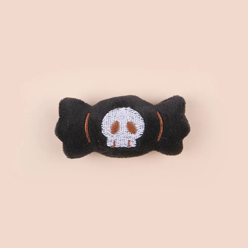 Plush cat teaser toy with three interchangeable heads: eyes, candy, and skull designs