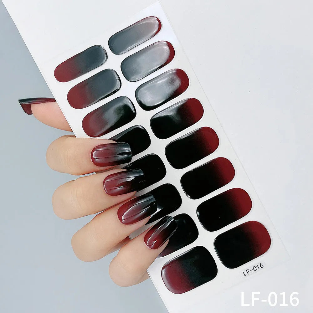 Set of 16 solid colour full nail art stickers showing patterns like cross, rose, tulip, and cartoon designs.