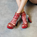 Women's black fish mouth high-top ankle boots with a Roman block heel and snake-skin texture.