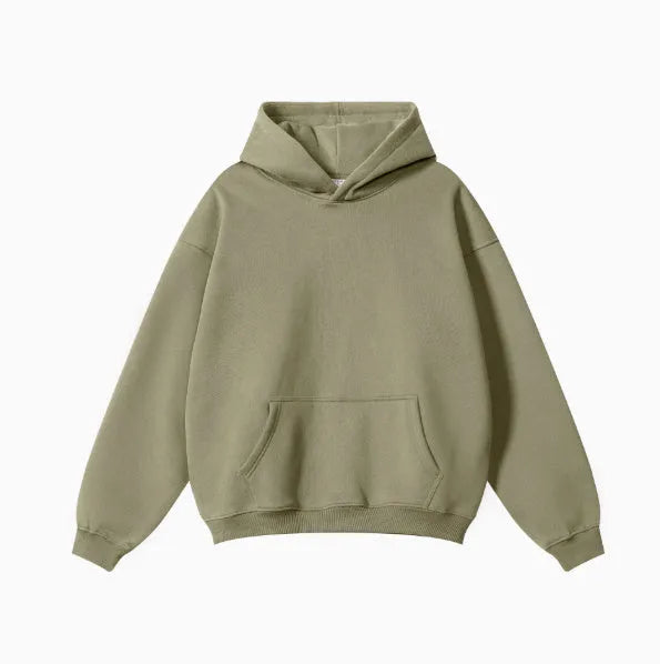 Man wearing a loose-fit grey terry cotton hooded sweater with drop-shoulder sleeves.