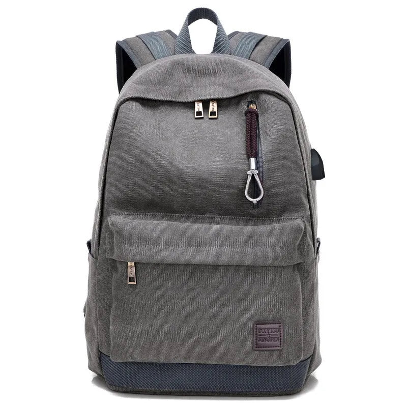 Canvas backpack with USB charging port showing multiple compartments including laptop pocket