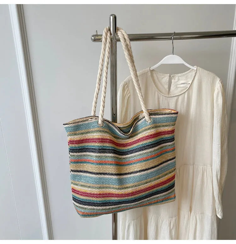 Blue straw woven nylon shoulder bag with a single strap and large main compartment