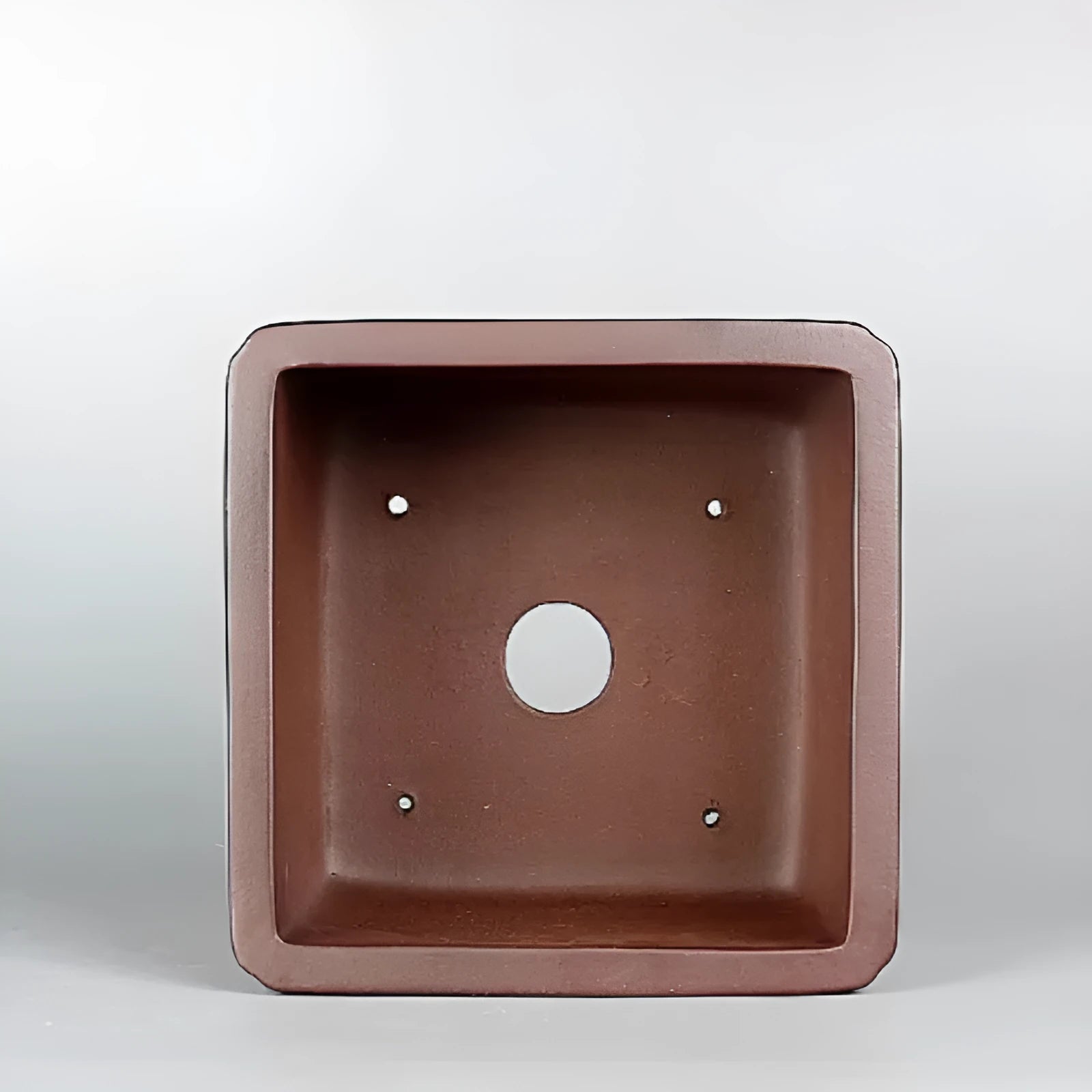 Brown handmade purple clay flower pot with antique styling and drainage hole