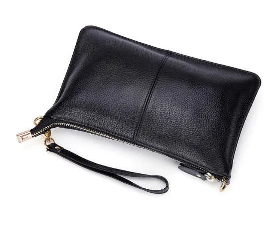 Structured cowhide lady slant bag in apricot colour with hand strap and shoulder strap, showing slim profile.