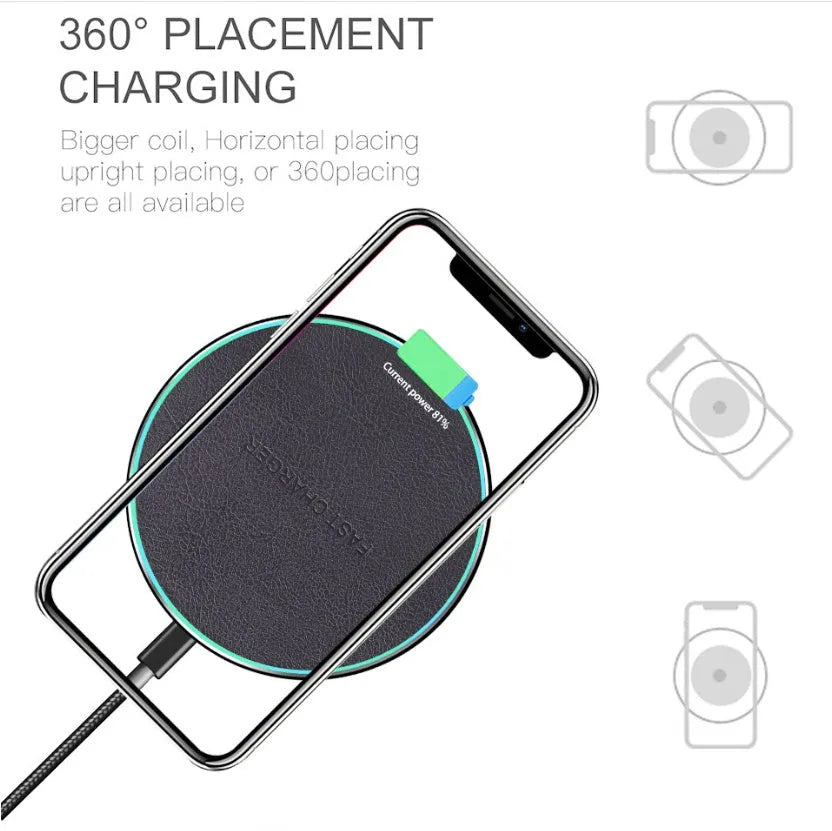 Black Qi wireless fast charging pad for iPhone 11 on a wooden surface.