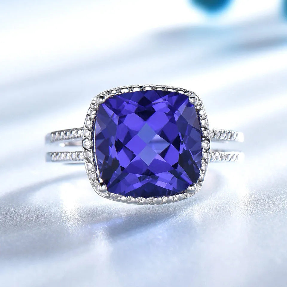 Women's sterling silver ring with blue tanzanite stone showing silver band and gemstone setting