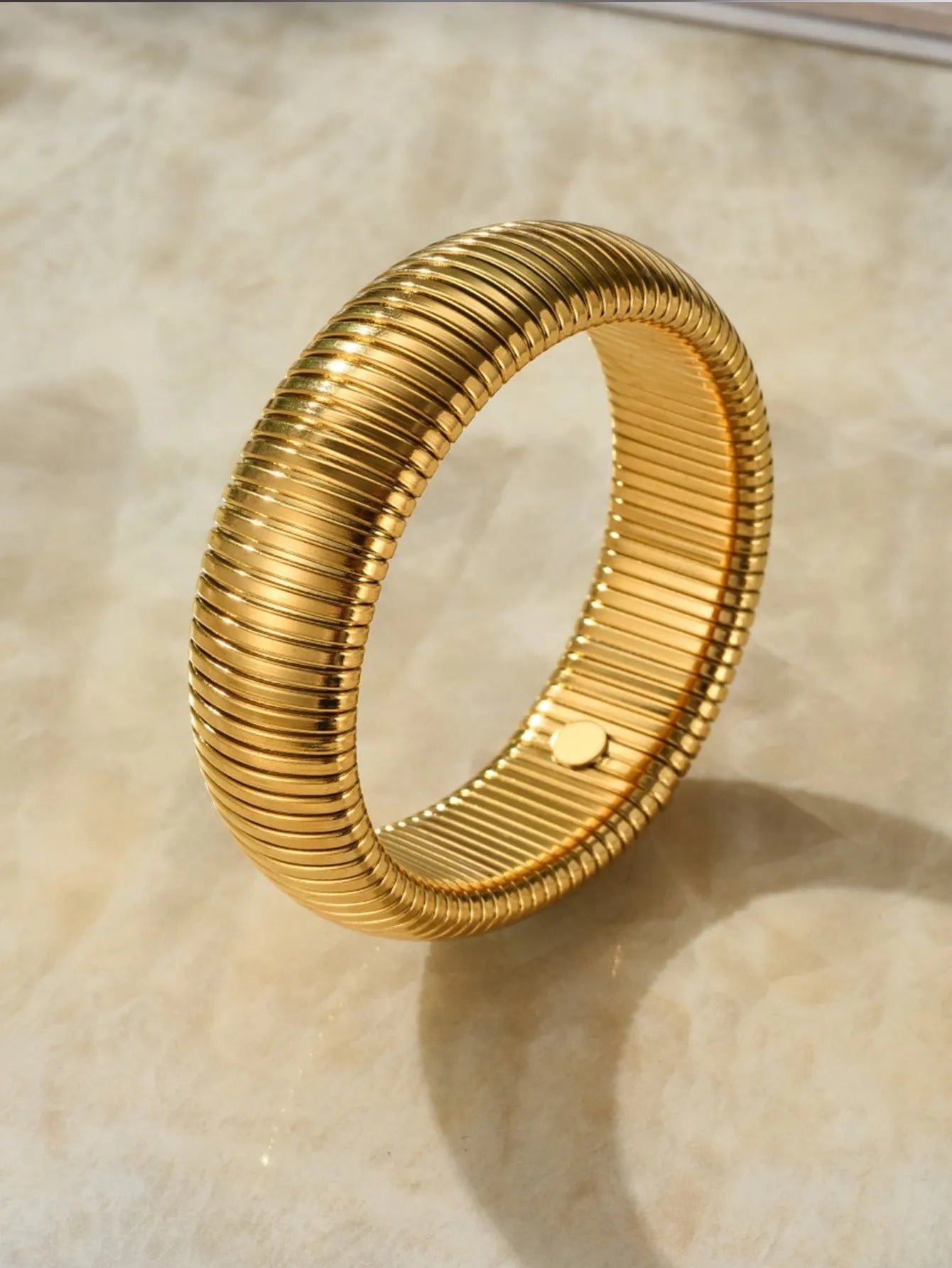 Women's elastic titanium steel bracelet with vertical stripe ring pattern in gold finish