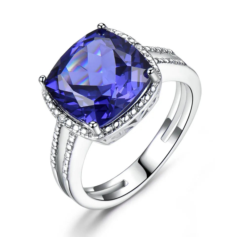 Women's sterling silver ring with blue tanzanite stone showing silver band and gemstone setting