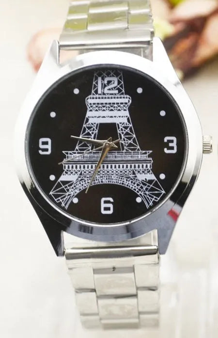 Round stainless steel watch with engraved Eiffel Tower design and Roman numeral markers