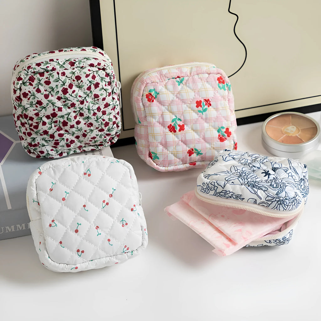 Yellow floral polyester key storage bag with sewing thread detail next to red small flower design variant.