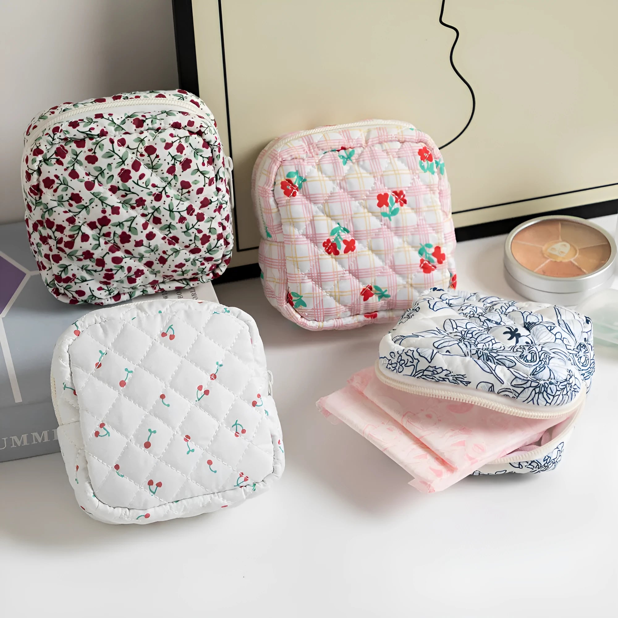 Yellow floral polyester key storage bag with sewing thread detail next to red small flower design variant.