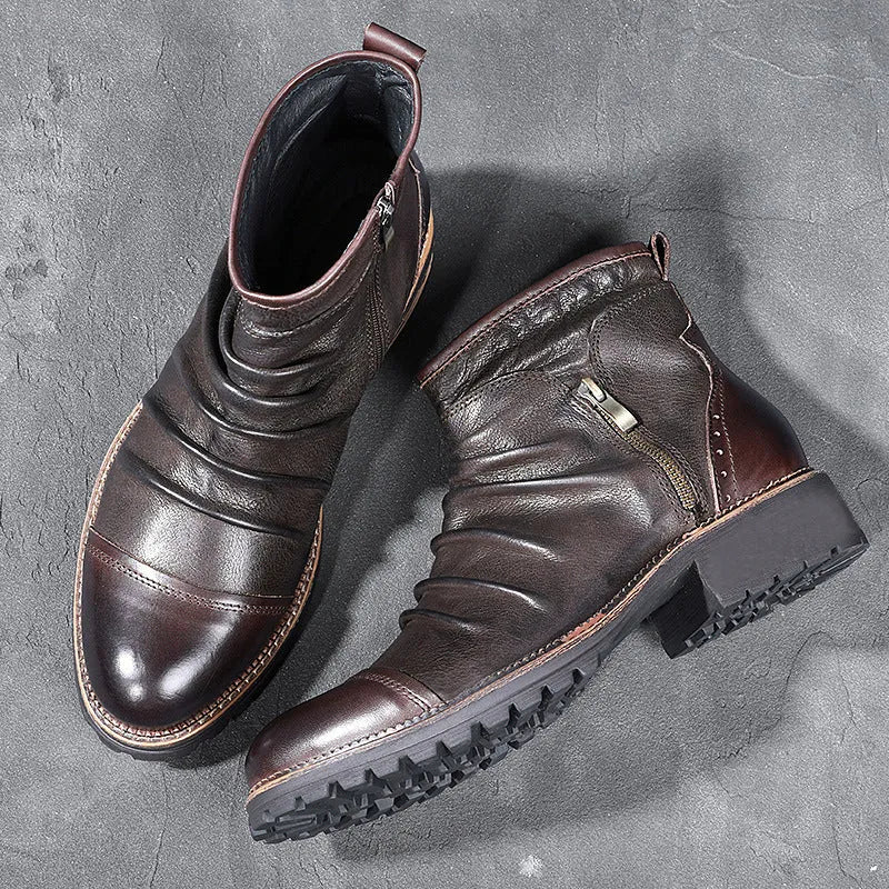 Men's black side-zip cowboy boots with a round toe and horseshoe heel on a wooden floor.