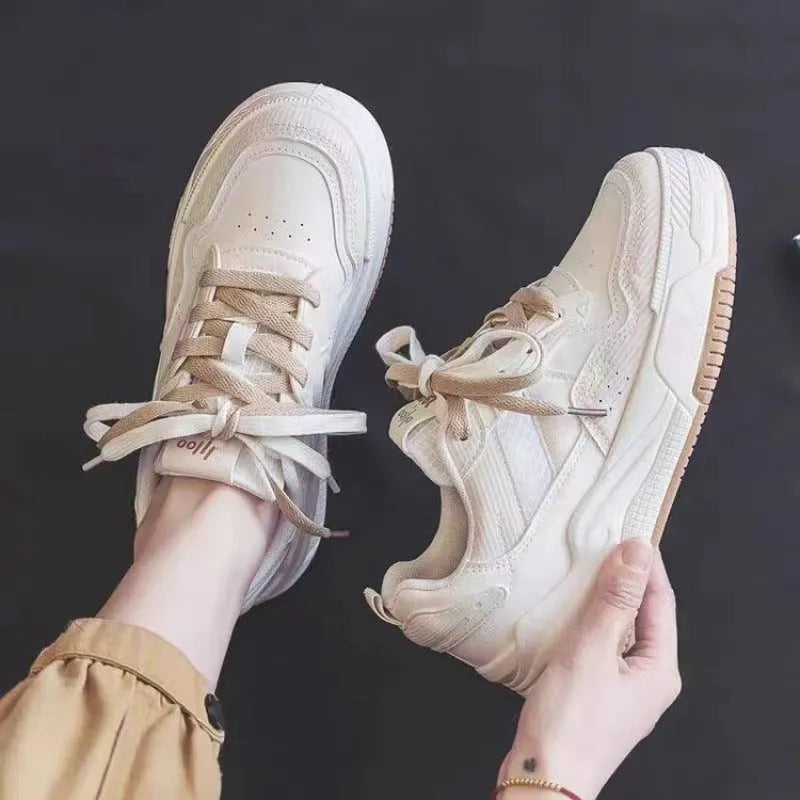 Pink and beige low-top sneakers with rubber soles and height-increasing design