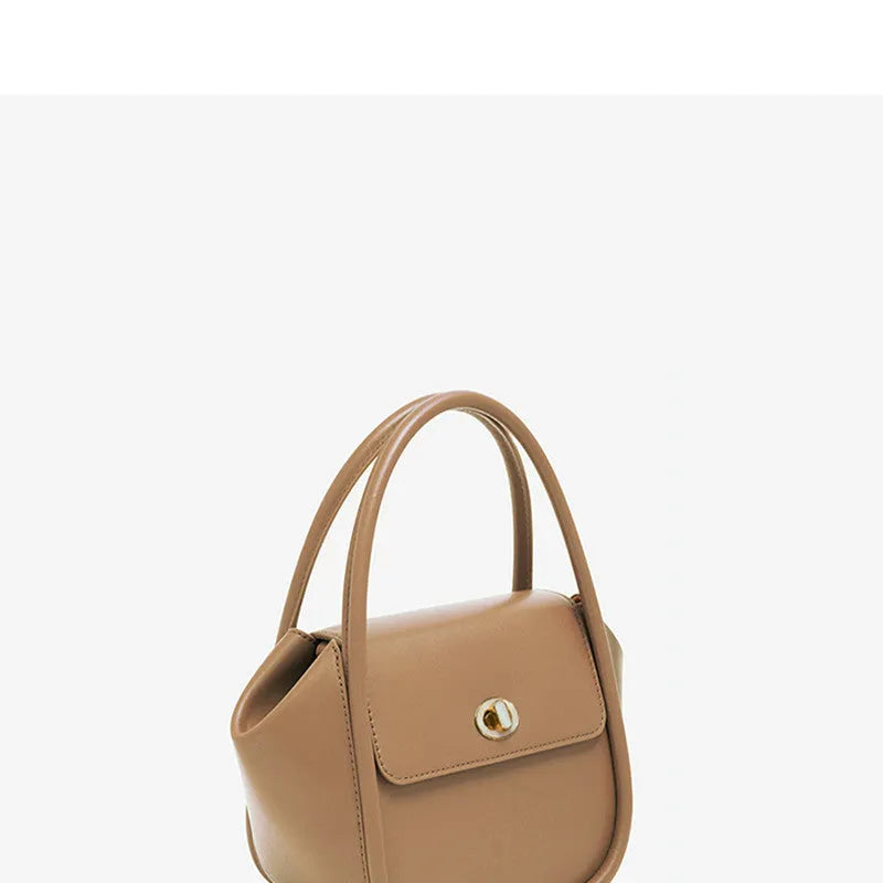 Women's leather wing-shaped tote bag with buckle closure in blue, grey, black, or brown colour options