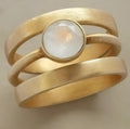 Gold plated titanium steel geometric ring with white chalcedony stone in micro-inlaid setting
