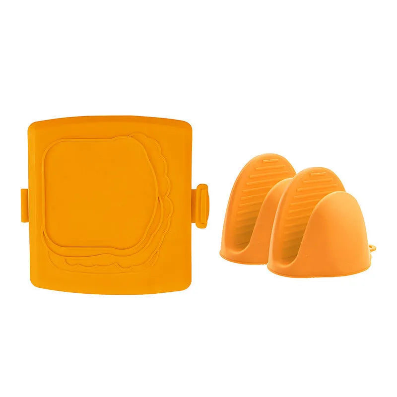 Red silicone baking tray and oven gloves set on a kitchen counter.