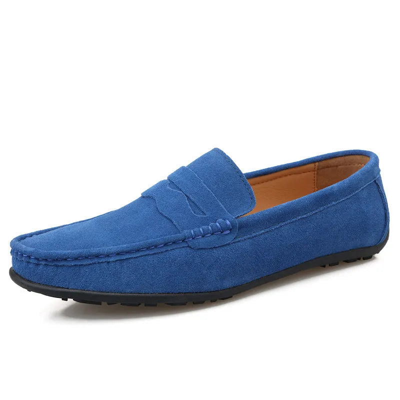 Men's solid colour suede loafers with round toe and rubber sole on a neutral background.