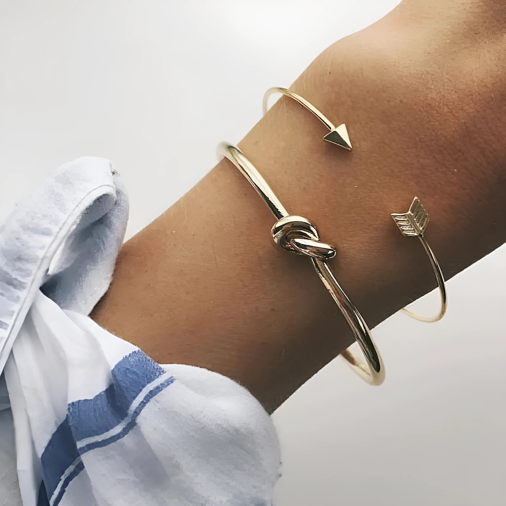 Gold electroplated alloy vintage cuff bracelet with arrow and knot design for women