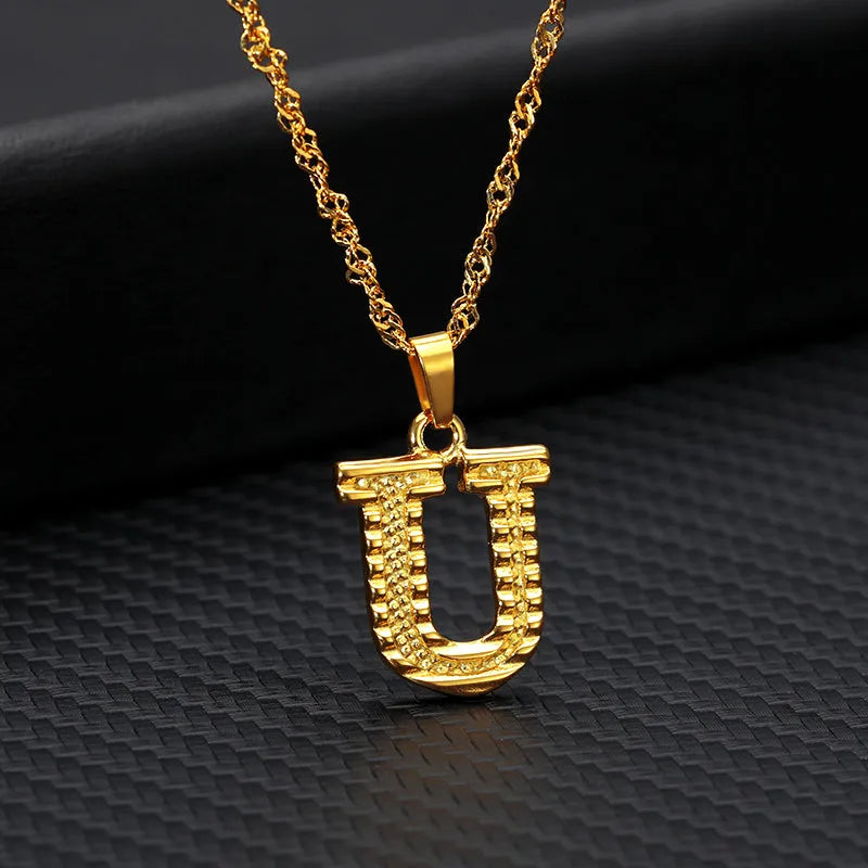 Gold-plated alloy initial pendant necklace with 42cm chain on white background