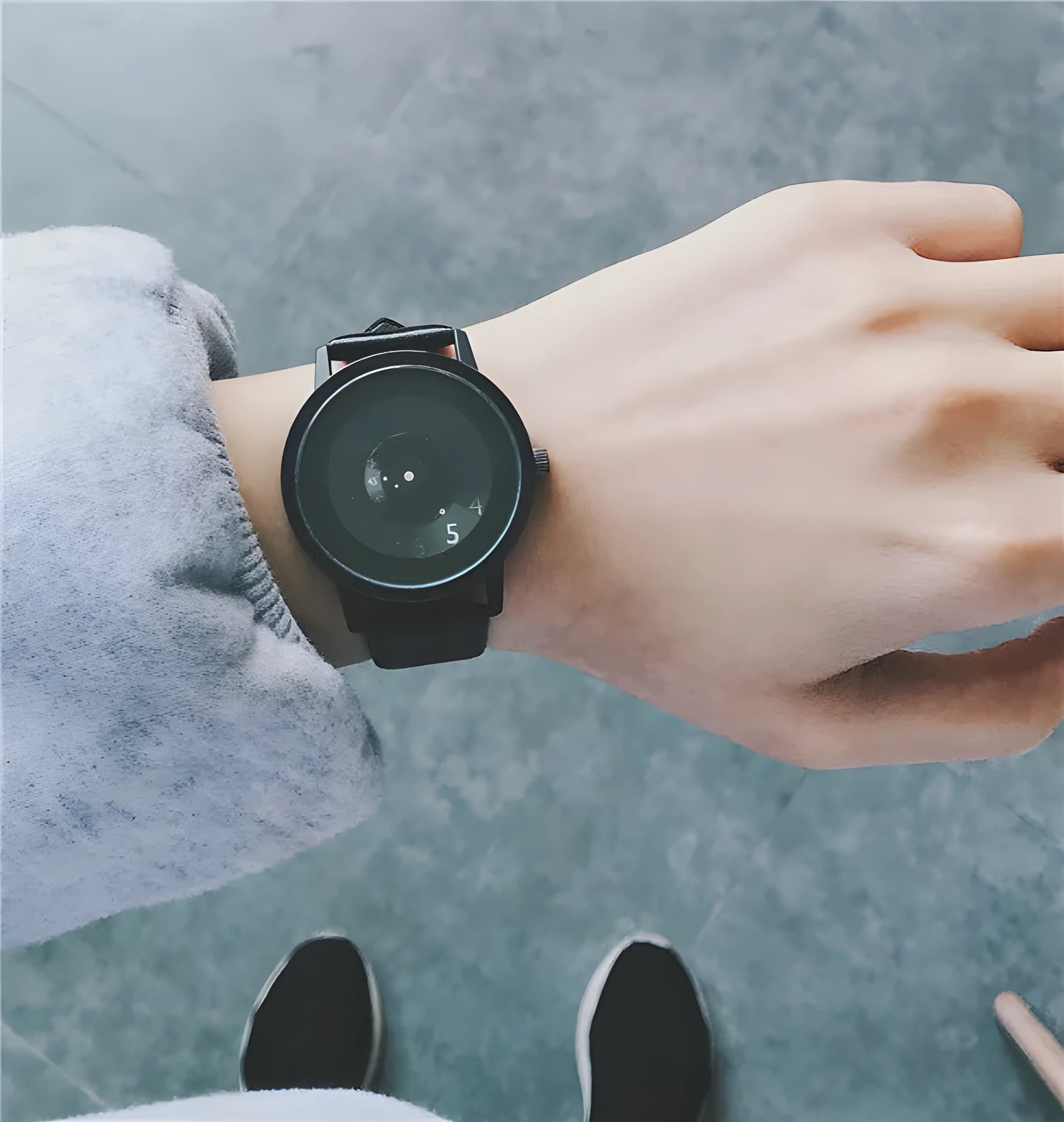 Casual unisex handless watch with pointer display, round dial, alloy case, and imitation leather strap on wrist