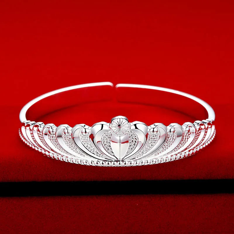 Silver electroplated crown bracelet for women on white background