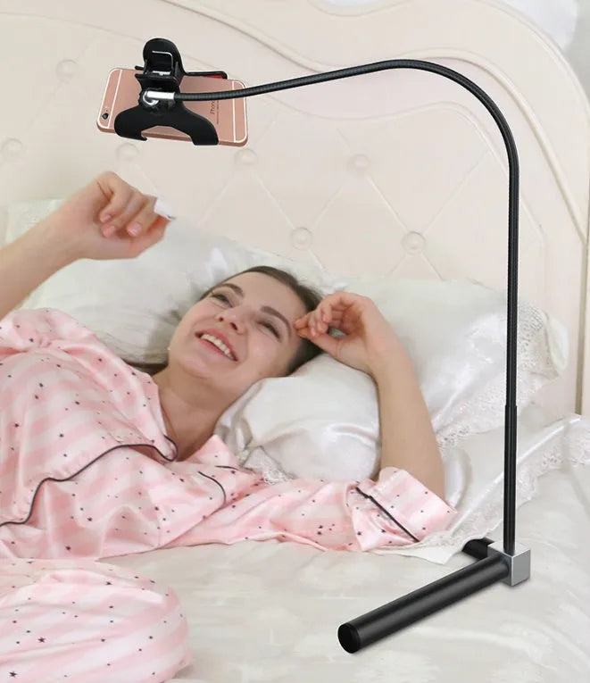 Black mobile phone bed bracket mounted bedside with adjustable overhead support shelf holding smartphone