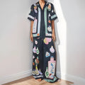 Black women's casual set with cartoon print, showing cardigan and matching trousers