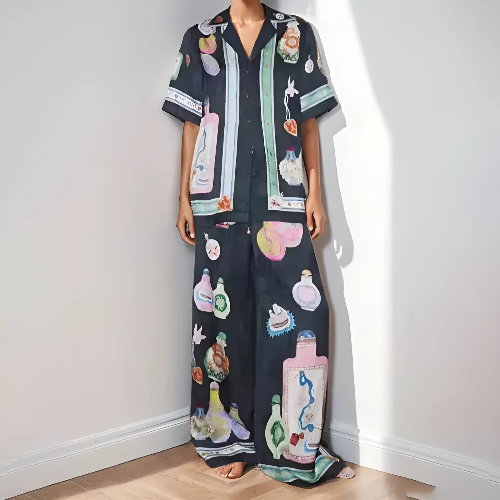 Black women's casual set with cartoon print, showing cardigan and matching trousers