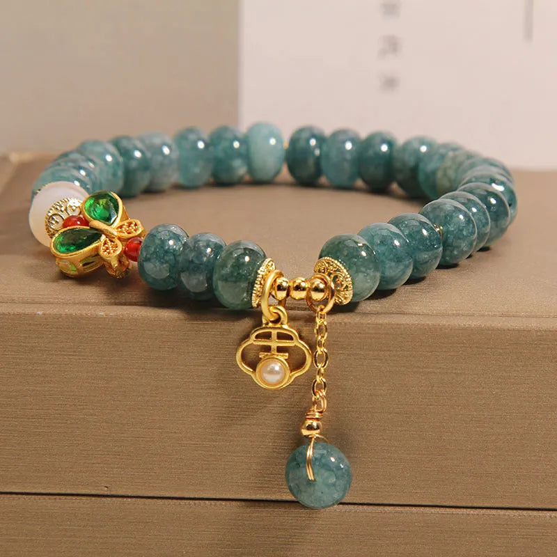 Blue water jade abacus bead bracelet with white agate and butterfly charm design