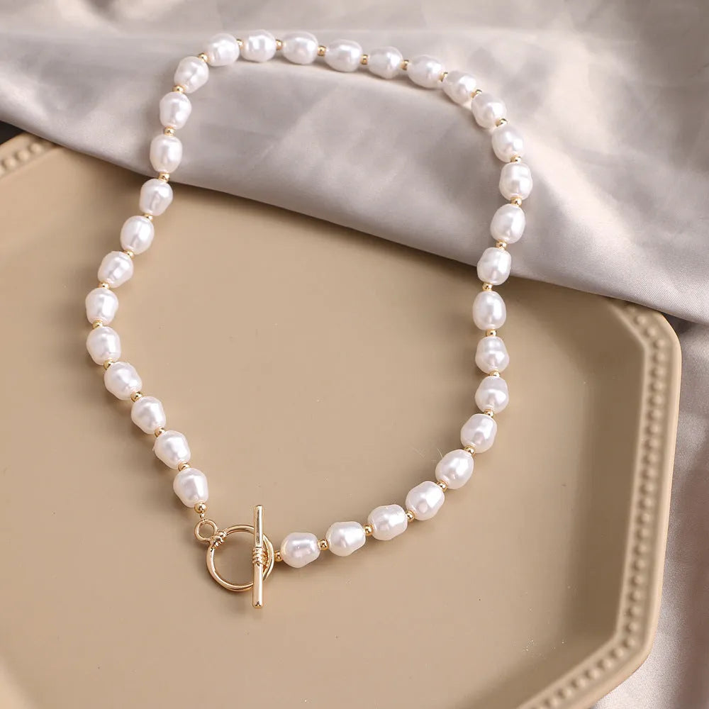 Vintage gold heart pendant necklace with pearl chain detailing showing adjustable length feature