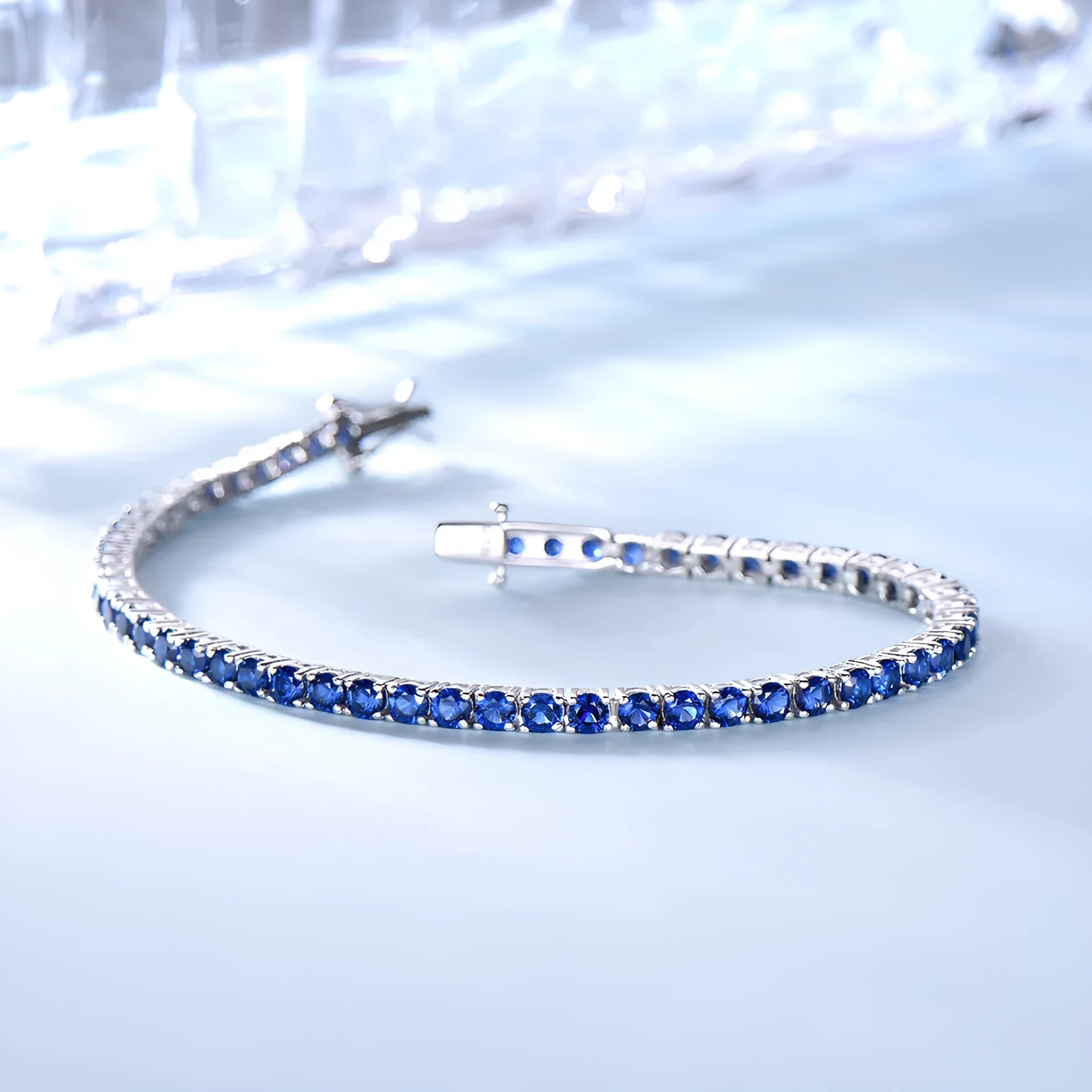 925 sterling silver nano sapphire tennis chain bracelet with drop shape stones on white background