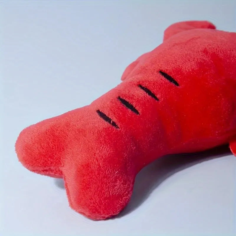 Red plush lobster-shaped squeaky dog toy for small and medium breeds.