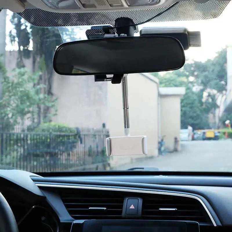 Black ABS plastic mobile phone bracket mounted on a car rearview mirror.