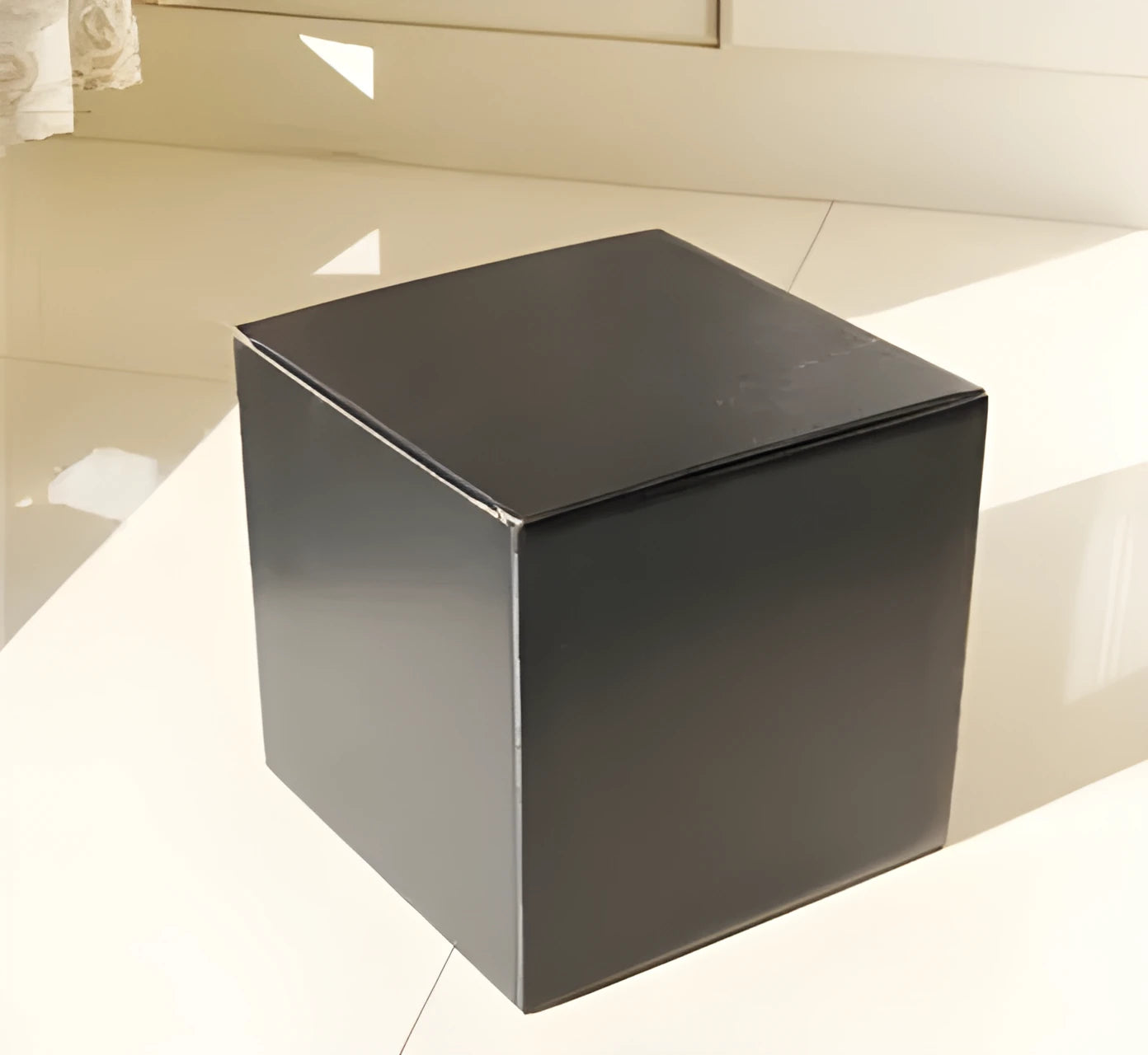 Square black corrugated cardboard packaging box with three internal compartment floors.