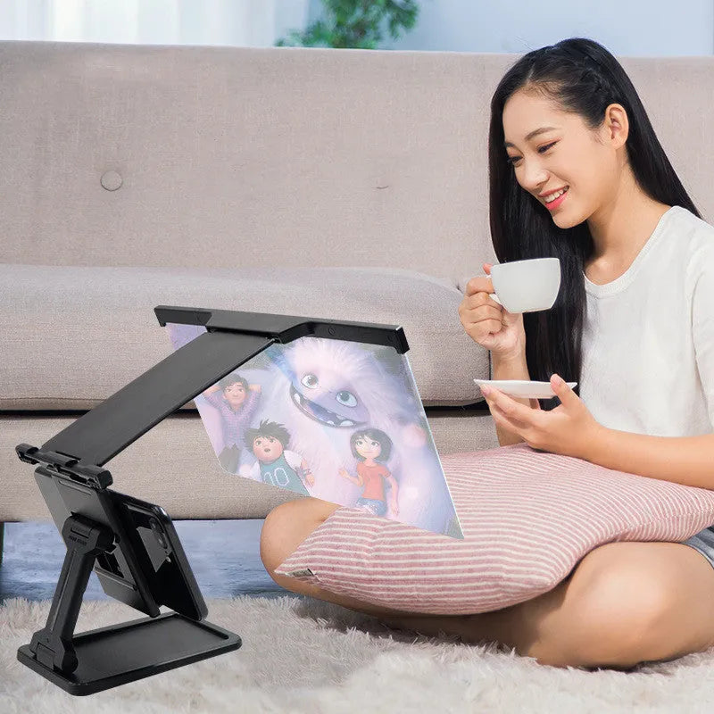 Black L20 mobile phone screen magnifier with 12-inch acrylic lens and folding ABS stand on a table.
