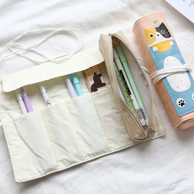 Rolling pencil case with grass green cat pattern on a school desk