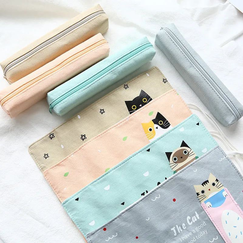 Rolling pencil case with grass green cat pattern on a school desk